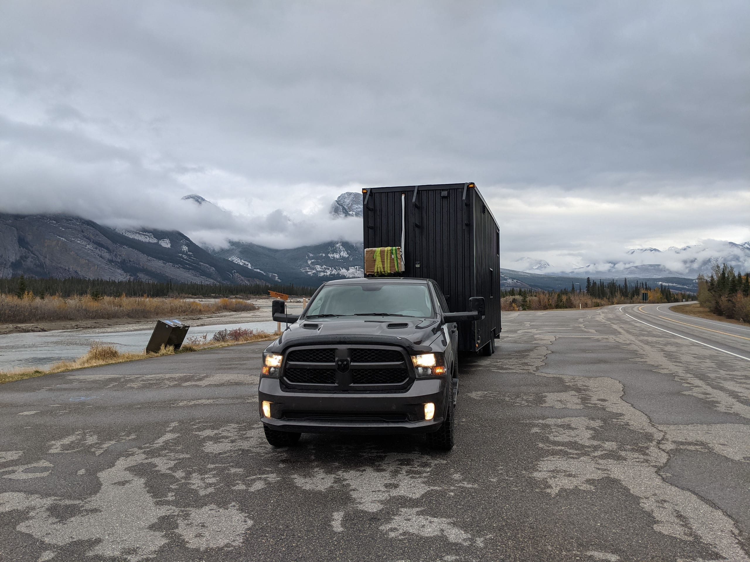 Historical photograph of the tiny house being towed by a truck on a highway
