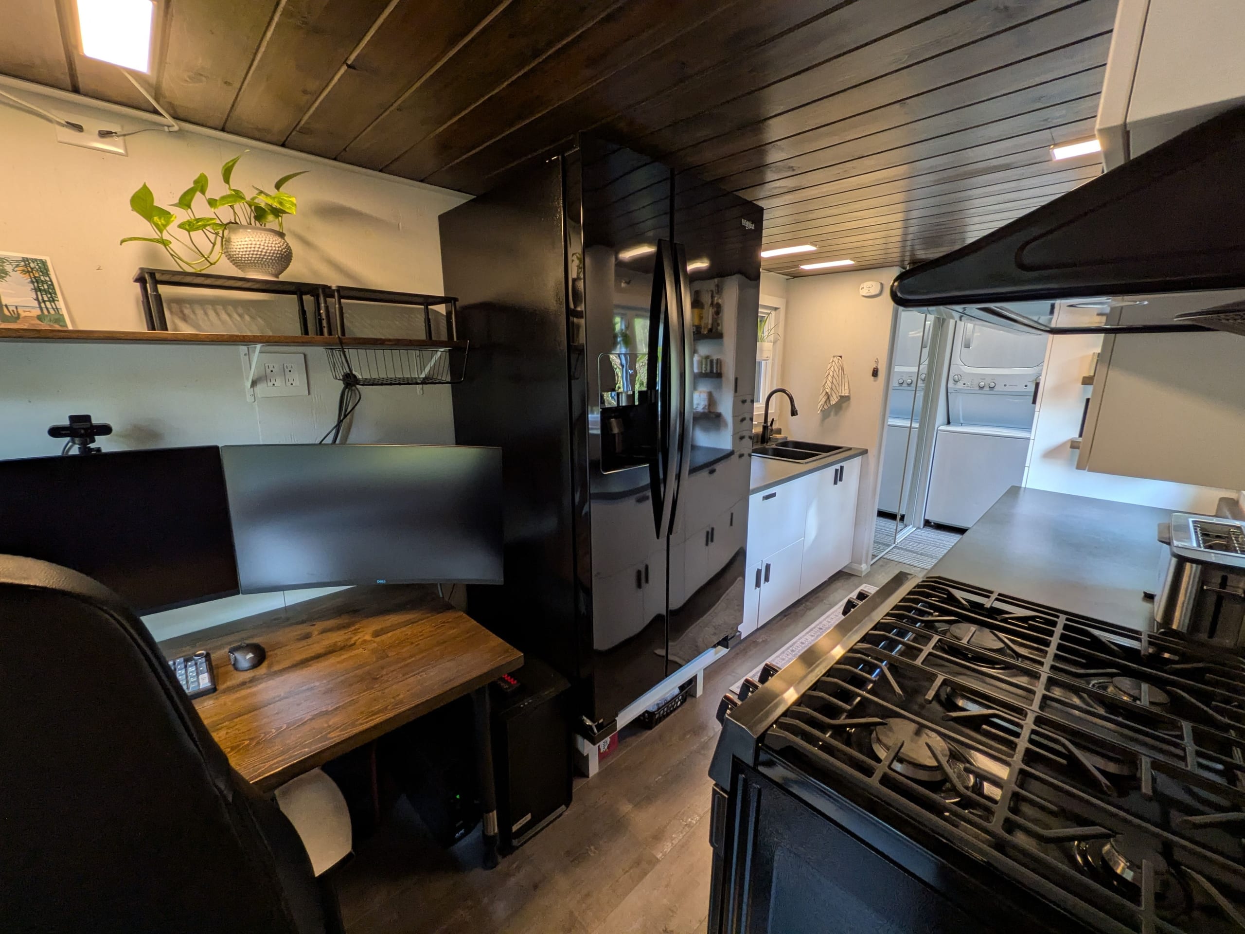 Dining and workspace beside the kitchen with refrigerator and stove