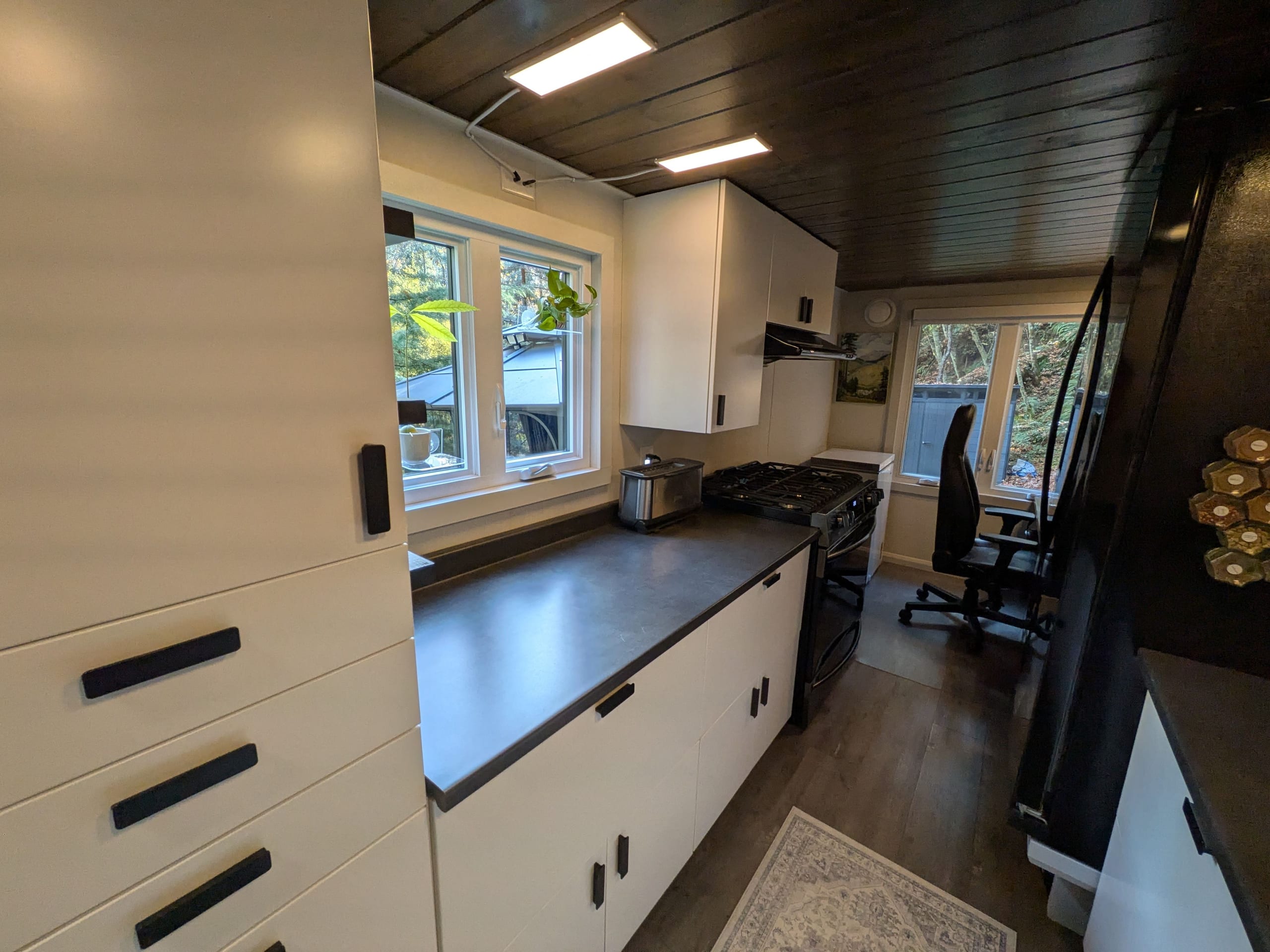 Kitchen with window, sink, cabinetry, refrigerator and stove